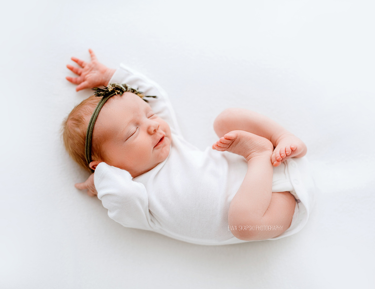 newborn baby on white blanket