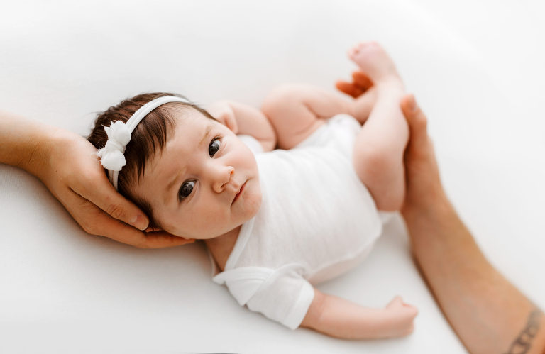 Newborn Baby with parents hands